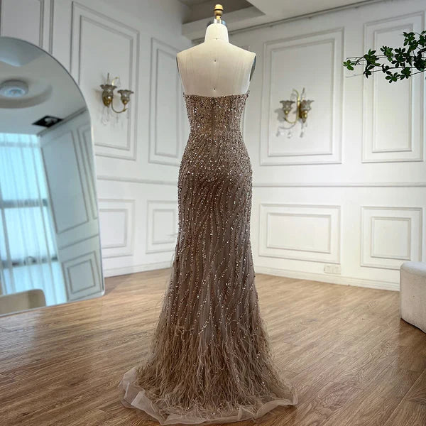 Woman wearing champagne formal evening gown dress gold beige nude skin intricate beading, feathered bottom, evening gown with a high slit, glitter sparkling diamonds, sweetheart neckline v-neck, mermaid, train, old-money classy elegant dubai style, saudi arabic, sleeveless,tom ford skin, prom, wedding guest, bridesmaid, mother of the bride, christmas, luxury, celebrity, expensive cheap, vintage, real photos, high-end, chooseone, viral, where to buy, now, shop, store, miss universe, best, number one top