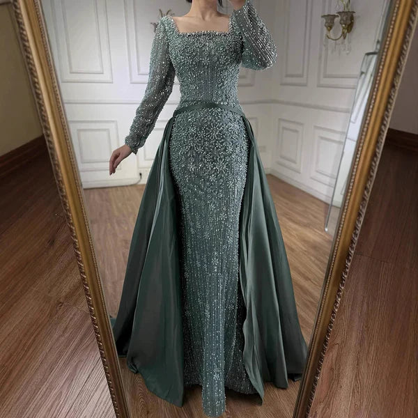 Woman in a sparkling green evening gown standing in front of a mirror.#2026 #bestonlineshop #missuniverse #besteveninggown #numberone #bestquality #top #eveningdress #mostpopular #cocktaildress #fittedeveningdress #cocktailparty #promdress #buynow #bridesmaid #weddingguestattire #styletrends #topfashion #weddingdress #bestclothingshop #formaldress