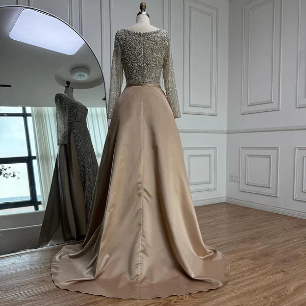 Elegant silver evening gown with long sleeves and a train, reflected in a mirror. Beaded, long train, silk, floor length, formal, dress, champagne colour, cream, beige, nude, skin colour, dubai style, middle east, muslim, old-money, classic, luxury, video, sparkle, glitter, real photos, 