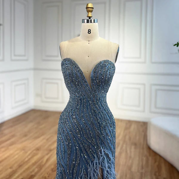 Woman wearing  blue formal evening gown  dress with a slit,intricate beading, powder baby blue, feathered bottom, evening gown with a high slit, glitter sparkling diamonds, sweetheart neckline  v-neck, mermaid, train, old-money classy elegant dubai style, saudi arabic, sleeveless, elliesaab, prom, wedding guest, bridesmaid, mother of the bride, christmas, luxury, celebrity, expensive cheap, vintage, real photos, high-end, chooseone, viral, where to buy, now, shop, store, miss universe, best, number one top