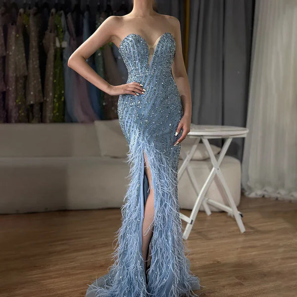 Woman wearing  blue formal evening gown  dress with a slit,intricate beading, powder baby blue, feathered bottom, evening gown with a high slit, glitter sparkling diamonds, sweetheart neckline  v-neck, mermaid, train, old-money classy elegant dubai style, saudi arabic, sleeveless, elliesaab, prom, wedding guest, bridesmaid, mother of the bride, christmas, luxury, celebrity, expensive cheap, vintage, real photos, high-end, chooseone, viral, where to buy, now, shop, store, miss universe, best, number one top