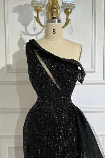 Black one-shoulder dress on a mannequin against a white wallglitter sparkling diamonds, side shoulder off the shoulder, mermaid, train, old-money classy elegant dubai style, saudi arabic, sleeveless, elliesaab, prom, wedding guest, bridesmaid, mother of the bride, christmas, luxury, celebrity, expensive cheap, vintage, real photos, high-end, chooseone, viral, where to buy, now, shop, store, miss universe, best, number one top, glamorous, sexy, simple, haul, shein, dance, formal, give me 