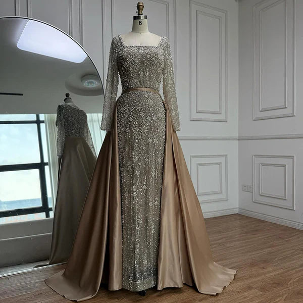 Elegant silver evening gown with long sleeves and a train, reflected in a mirror. Beaded, long train, silk, floor length, formal, dress, champagne colour, cream, beige, nude, skin colour, dubai style, middle east, muslim, old-money, classic, luxury, 